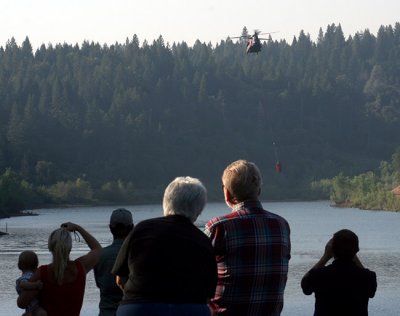 6-30: Onlookers watch Chinook copter fill up at Magalia Reservoir