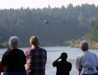 6-30: Onlookers watch Chinook copter fill up at Magalia Reservoir