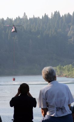 6-30: Onlookers watch Chinook copter fill up at Magalia Reservoir