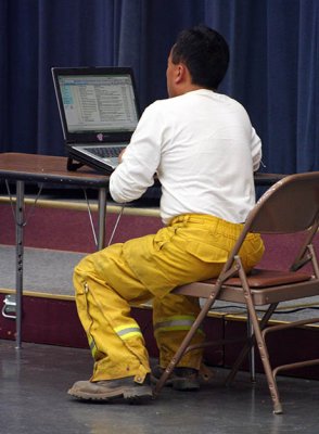 6-26: Visiting firefighter, on break, checks e-mail at Magalia Community Center