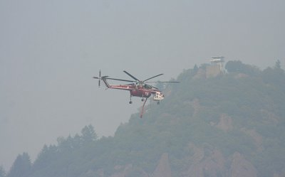 6-29: Army helicopter flies past a smoky Sawmill Peak Lookout, Magalia