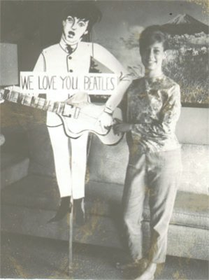 My mom with home made Beatle sign for concert, 1964