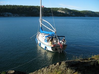 anchor off bow, mooring lines to shore in Baie Fine
