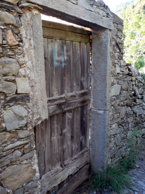 Gate in a stone wall surrounding a vineyard.