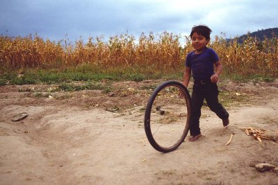 Young Boy Running With Wheel