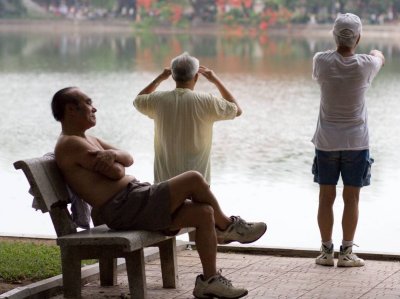 Hundreds of people, many of them elderly, exercise at Hoan Kiem Lake each morning