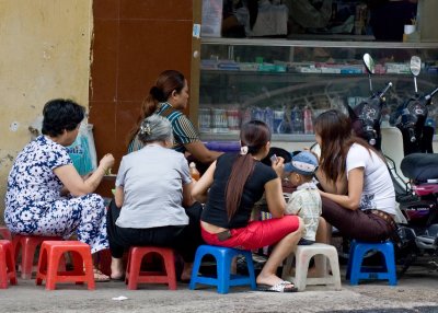 Small informal sidewalk food stalls with plastic stools for seating are very common in Hanoi