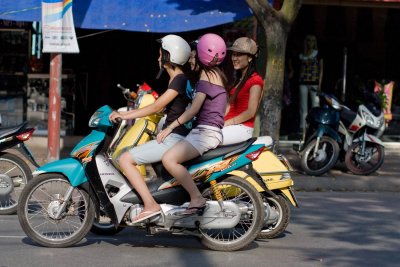 Teenage scooter girls chatting as they ride