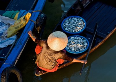 Maneuvering her boat toward the dock