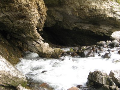 The river disappears into the ground into a cave