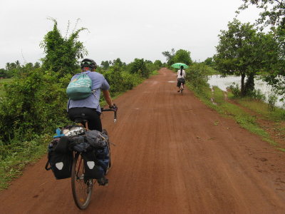 I never tried riding with an umbrella, although we saw many people riding with them