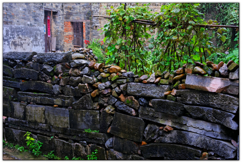 9 House Village, wall made of gravestones