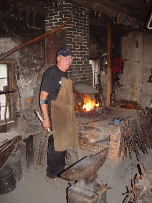 THIS BLACKSMITH SHOWED US HOW IRON WAS FORMED TO MAKE THE NECESSARY UTINSELS OF THE DAY
