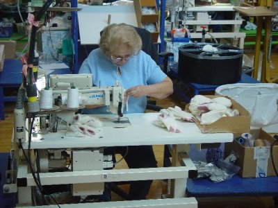 THIS WOMAN WAS SEWING THE BEAR PARTS TO MAKE A TEDDY