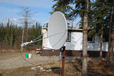 YOU KNOW YOU ARE IN ALASKA WHEN THE INTERNET DISH IS AIMED ALMOST TO THE GROUND