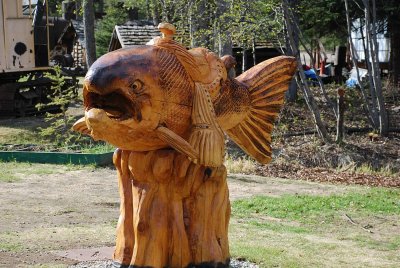 ONE OF THE MANY WOOD CARVINGS AT THE SALMON BAKE-WANT TO RIDE A SALMON?