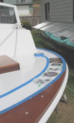 Plastic lids used as spacers to set the inner mask line for the nonskid on foredeck.