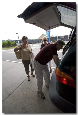 Ron helps them unload luggage.