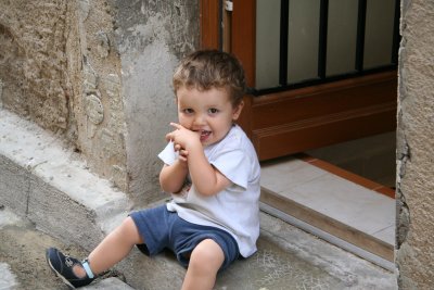 Little boy sitting on steps