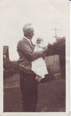 Frank holding his granddaughter Eleanor Joy Mitchell on Christening day 1943