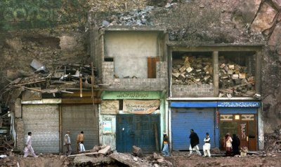 Earthquake survivors walk through devastated town of Chanari.jpg