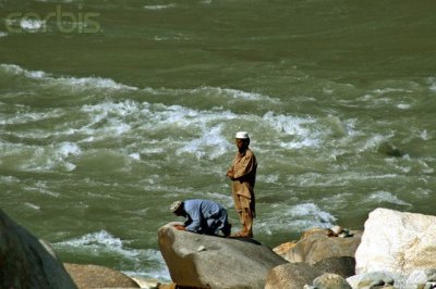 Muslims offer prayers at the banks of the river Chenab