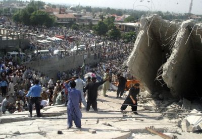 Pakistani volunteers work at a collapsed building following an earthquake in Islamabad.