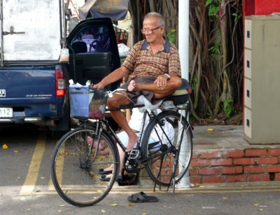 This Indian man was taking a break resting on his bike.