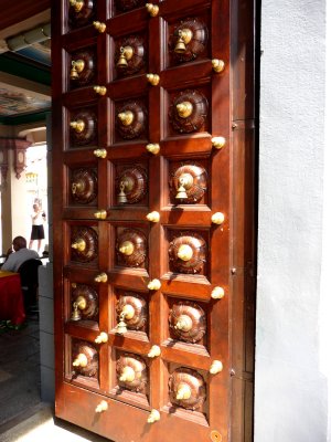 Elaborate door at the Hindu temple with multiple bells.