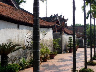 Pathway in the But Thap Pagoda with palm trees.