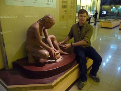 Me pretending to make pottery with this replica of an ancient Vietnamese woman.