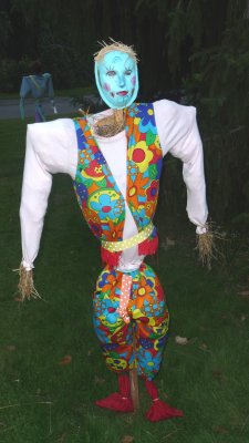 Colorful scarecrow with a clown-like costume.