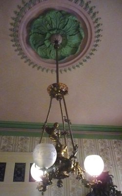 Gaselier chandelier. The wallpaper and ceiling colors are reproductions of what Adelicia had when she built Belmont Mansion.