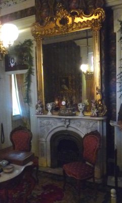 Mantel inside the Ladies Parlor with decorative porcelain pieces and a clock.