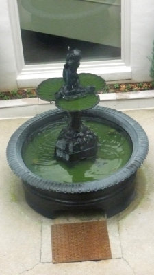 This fountain, which is now in the back courtyard, used to be inside the house.
