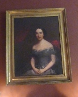 An portrait of an older Adelicia in the Family Dining Room.