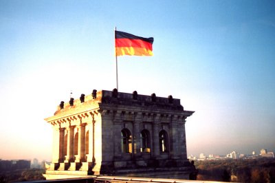 The top of the Reichstag with the German flag flying.