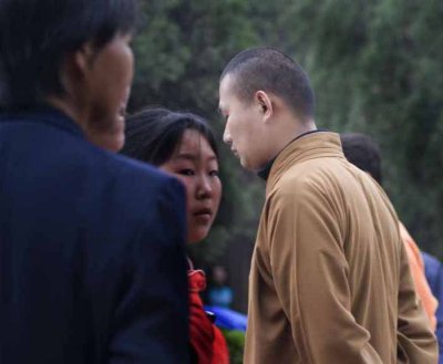 Monk alone in crowd