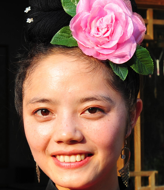 Beautiful, freckled Miao Museum attendant