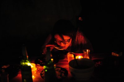 Late dinner outdoors, illuminated only by 2 candles