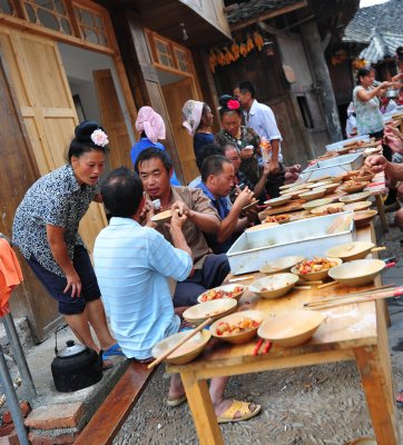 Xijiang Miao Village - drinkin strong alcohol at a street party