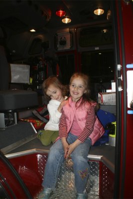Madison and Faith posing in the shiny new pumper truck