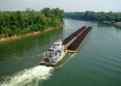 A towboat with coal barges makes a turn on the Cumberland River
