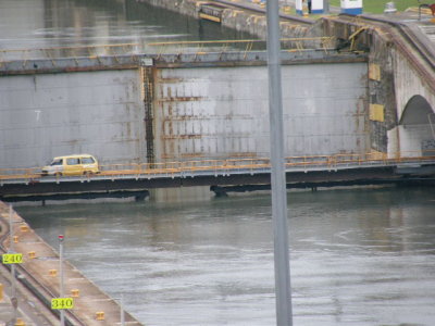 Van crosses a swing-out bridge at the Gatun locks under a wall of water..JPG