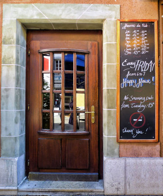 A pub door advertising happiness