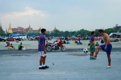 Locals play football near Grand Palace