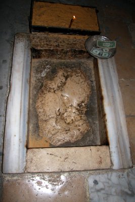 Stone with a cavity inside of the Chapel of Ascension