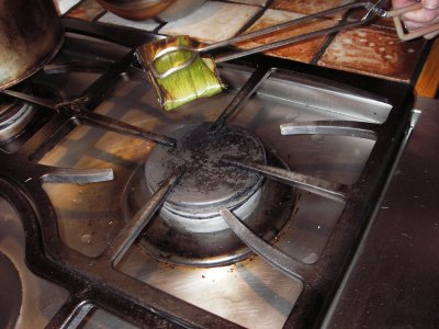 Toasting shrimp paste in banana leaf packet