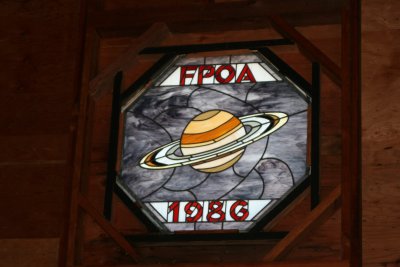 Stain glass logo on the north wall