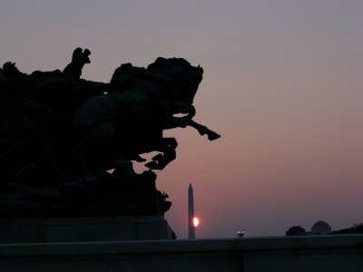 monument at sunset with horses